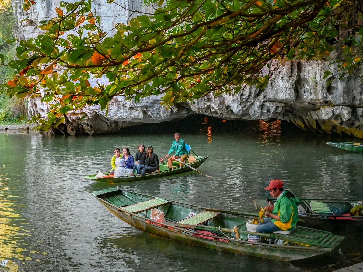 A wooden boat entering the river cavern of Phong Nha Cave