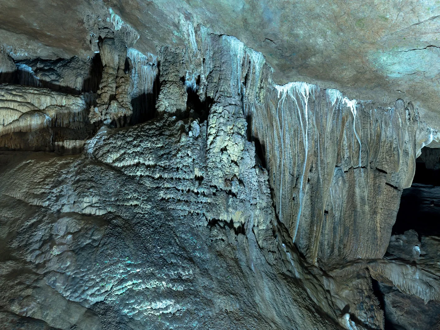 Illuminated limestone formations inside Paradise Cave, Phong Nha